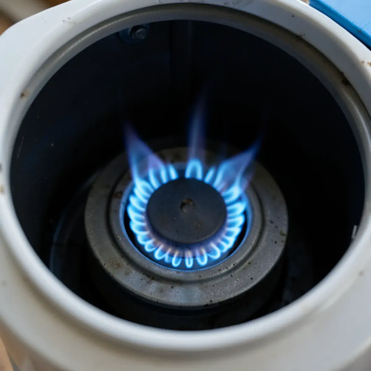 Steady blue pilot flame inside a gas water heater